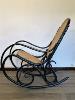 ROCKING CHAIR NOIR EN BOIS ASSISE CANNAGE. 1960 