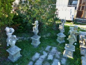  FOUR MUSICIANS PUTTI STATUE IN DRESSED STONE.